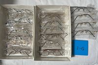 two trays and additional column showing all individually wrapped eyeglasses
