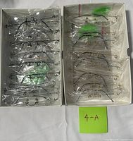 Two trays with approximately 18 individually bagged eyeglass frames