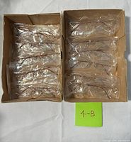 Two boxes containing sealed eyeglass frames, showing overall quantity