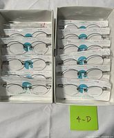 Two boxes containing multiple sealed eyeglass frames