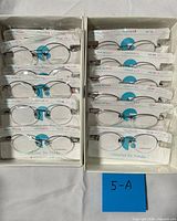 Two boxes each holding six sealed eyeglass frames