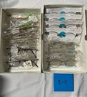 Both boxes showing all packaged eyeglass frames