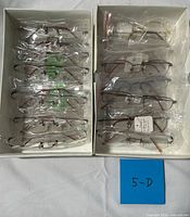 Two boxes showing all packaged eyeglass frames