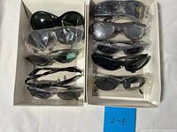 Two trays showing all nine pairs of sunglasses