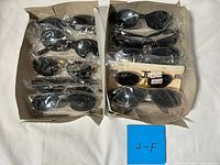 Two trays with about 12 pairs of sunglasses