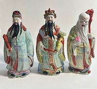 Front view of three Jingdezhen porcelain statues