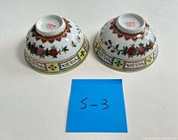 Underside view showing red maker’s mark and exterior decoration of both bowls