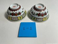 two porcelain bowls upside down showing pattern and backstamp