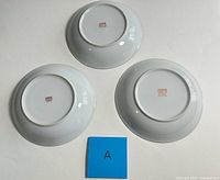 Backs of three plates showing hallmark stamps