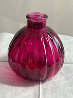 Front view of magenta ribbed glass vase