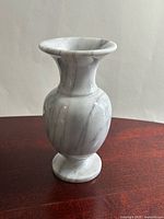 Front view of white marble vase with grey veining
