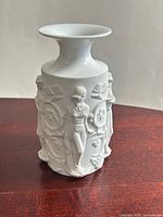 Front view of white porcelain relief vase