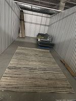 Unrolled grey striped area rug displayed on floor