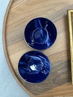 Top view of both cobalt blue soup bowls showing marbled swirl and gold rim