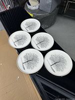 All five plates laid out showing identical tree design