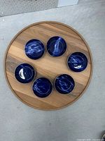 Top view of all six matching blue marbled salad bowls