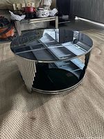 Full view of round chrome and glass coffee table