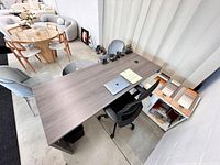 Top view of grey laminate L-shaped desk with white return