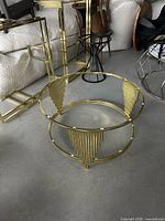 Gold round frame with fluted triangular panels and adjacent gold rectangular frames