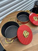 Both casserole pots with lids removed showing interiors