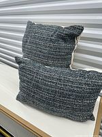 Two pillows showing charcoal tweed sides