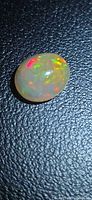 Front view of oval Ethiopian opal showing multi-color play-of-color