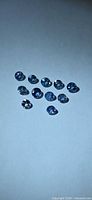 Group of round blue sapphires arranged on white background