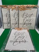 Four sealed stacks of identical gift bags