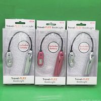 Front view of three packaged Travel-FLEX book lights