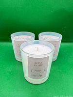 Three identical Rose Glow candles grouped together