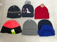 Group shot of all six knit beanies displayed flat