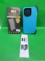 Box of Nano Ultimate screen protectors, blue case standing upright beside it