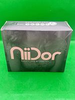 Front of boxed Niidor strapless adhesive bra