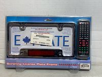 Sealed package showing license plate frame and remote