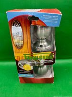 Front view of sealed Tough Guard privacy lock packaging with satin nickel knobs