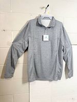 Full front view of grey long-sleeve quarter-zip polo on hanger