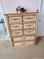 Front view showing five drawers with pink floral accents