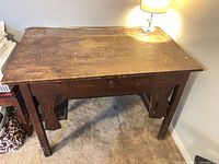 Top view of oak writing table showing surface wear and drawer