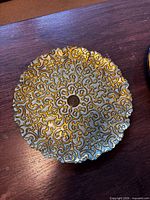 Top view of scalloped gold scroll platter