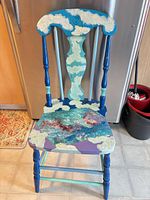 Front view of the hand-painted chair showing crest rail, seat artwork and leg detailing