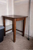 Overall view of hardwood bar-height table showing top, legs, finish, stretcher