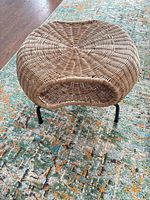 Top view of round wicker rattan ottoman showing weave pattern and shape