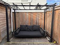 full view of swing frame with hanging daybed and cushions