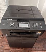 Front and top view of Brother printer showing control panel and exterior condition