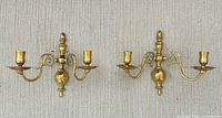 Front view of both brass sconces showing arms and drip pans