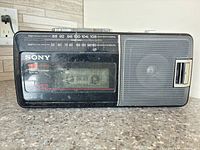 front view showing speaker, tuner scale, cassette deck