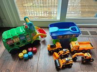Overall lot showing shape sorter bus, Paw Patrol wagon, four CAT vehicles and shape blocks