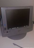 Tablet installed in docking cradle, screen visible