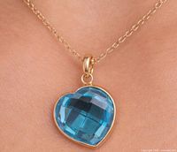 Pendant worn on chain to show scale and appearance