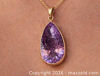 Pendant on chain showing scale and front view